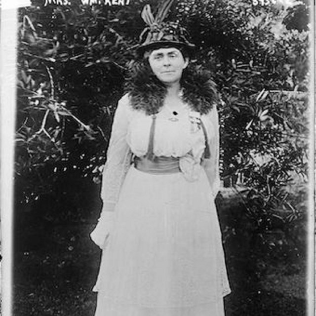 Black and white photo of a woman in a white dress